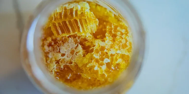 Close-up view of fresh honeycomb pieces in a jar